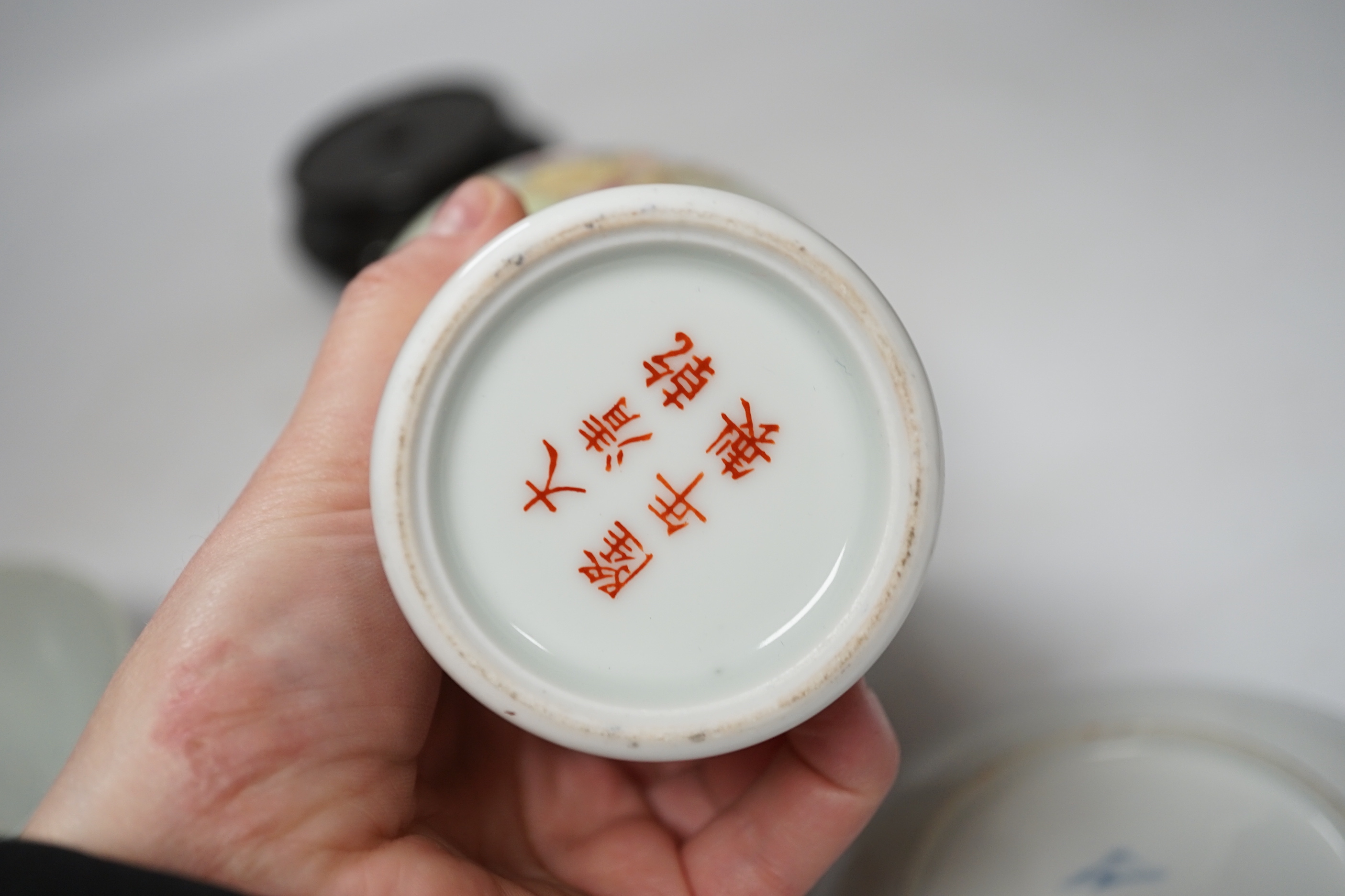 A Chinese famille rose vase, a rice dish, saucer and wooden stands